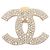 Chanel Broche dourada com strass