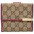 Cartera bi-fold Gucci GG Canvas con placa de metal