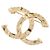 Spilla Chanel in metallo dorato con logo Coco