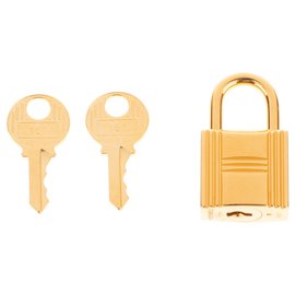 Hermès-Lucchetto dorato di Hermes per borse Birkin in oro kelly, nuova condizione con 2 chiavi e custodia originale!-D'oro