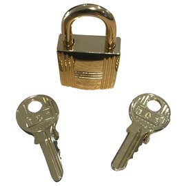Hermès-Hermès golden steel padlock with 2 keys-Golden