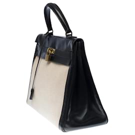 Hermès-Stunning Hermes Kelly handbag 35 inverted cm in black box leather and beige canvas, garniture en métal doré-Beige