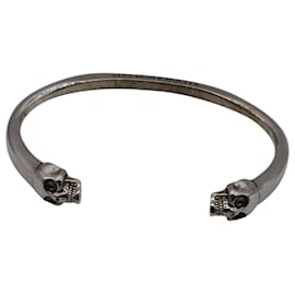 Alexander Mcqueen-Bracciale Alexander McQueen Twin Skull Cuff in ottone argentato-Argento