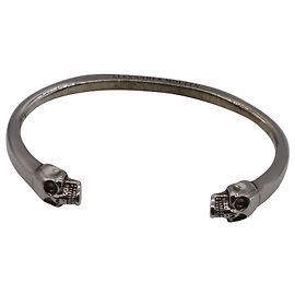 Bracciale Alexander McQueen Twin Skull Cuff in ottone argentato Argento