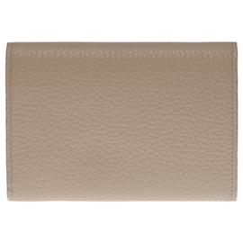 Louis Vuitton-LOUIS VUITTON CAPUCINES COMPACT WALLET IN PEBBLE GRAY TAURILLON LEATHER-Other