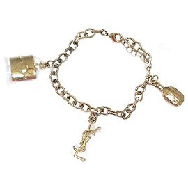 Pulsera Yves Saint Laurent con dijes - Oro - Ajustable - Nuevo Dorado