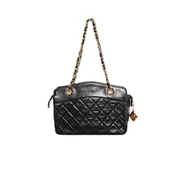 Chanel-Chanel, Mini sac à main matelassé vintage en cuir d'agneau noir avec détails dorés.-Noir