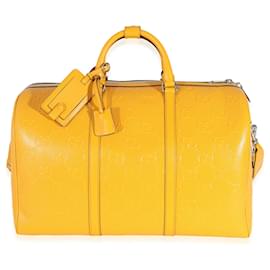 Gucci-Bolsa de viaje convertible con GG de piel de becerro perforada y grabada en amarillo Gucci-Amarillo