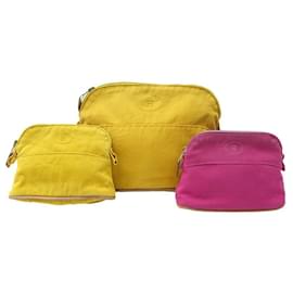 Hermès-LOT HERMES 3 BOLIDE POUCHES IN PINK AND YELLOW CANVAS CANVAS POUCH CLUTCHS-Other
