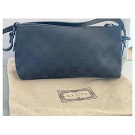 Gucci-Gucci canvas clutch with black leather handle-Monogram