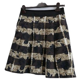 Falda plisada Kenzo de algodón negra Negro Crudo Bronce Marrón oscuro