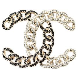 Broche de strass preta e dourada da Chanel Dourado