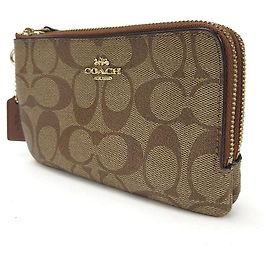 Bolsa de PVC con firma Coach Castaño