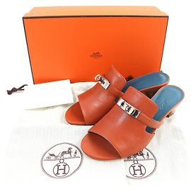Hermès Mules de couro com fivela Hermes Kelly marrom Marrom