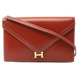 Clutch Lydie em couro box marrom da Hermès Marrom
