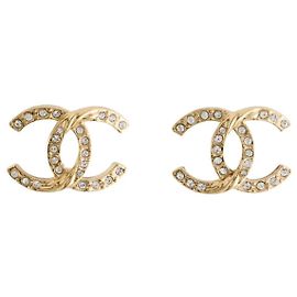 Orecchini Chanel in metallo dorato e strass D'oro