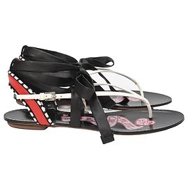Alaïa Graphic Print Gladiator Sandals in Black Leather Black