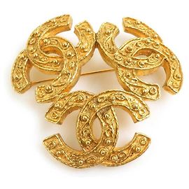 Broche en métal doré Chanel Coco Mark Doré