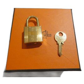 Cadeado Hermès em aço dourado para bolsas Hermès Kelly, Birkin, com caixa listrada Gold hardware