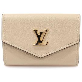 Louis Vuitton Cartera mini de piel de ternera beige greige con cierre dorado Castaño
