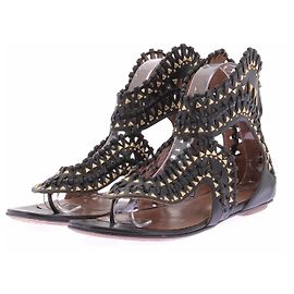 Alaïa Sandali piatti neri e dorati Nero