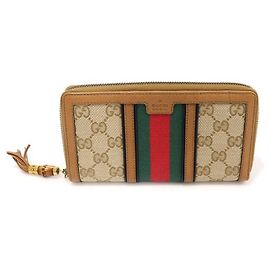 Gucci Portafoglio lungo con zip Rania in bambù con jacquard logo GG e nappina WEB Marrone