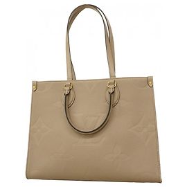 Borsa tote OnTheGo MM in Monogram Empreinte Louis Vuitton Beige