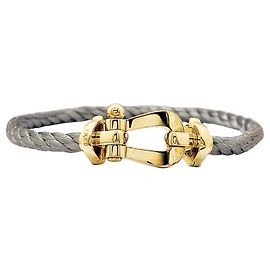 Bracelet Fred, "Force 10", or jaune, acier.  Autre