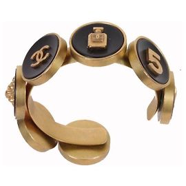 Pulseira rígida Chanel Camélia, N°5 e cabeça de leão Preto Dourado