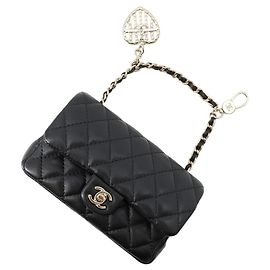 Charm per borsa Chanel in nero e oro champagne Nero D'oro