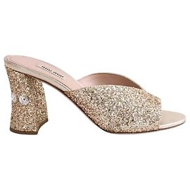 Mule Miu Miu dorate con paillettes D'oro