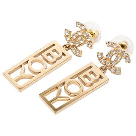 Orecchini Boy Swing in ottone e strass con CC Chanel dorati D'oro