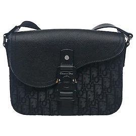 A strap bag in jacquard canvas material showcasing Dior's asymmetric saddle flap silhouette. The iconic Oblique pattern delivers an original sensibility while showing durability resistant to external Black