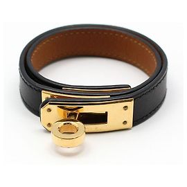 Hermès Pulsera Kelly de doble correa chapada en oro Castaño