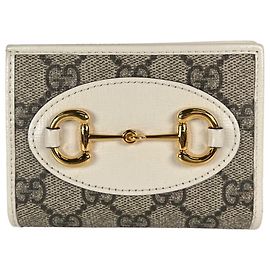 Cartera bi-fold Gucci de lona GG marrón Castaño