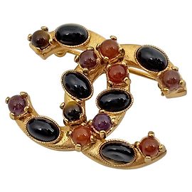 Broche Chanel plaquée or avec pierre colorée Doré