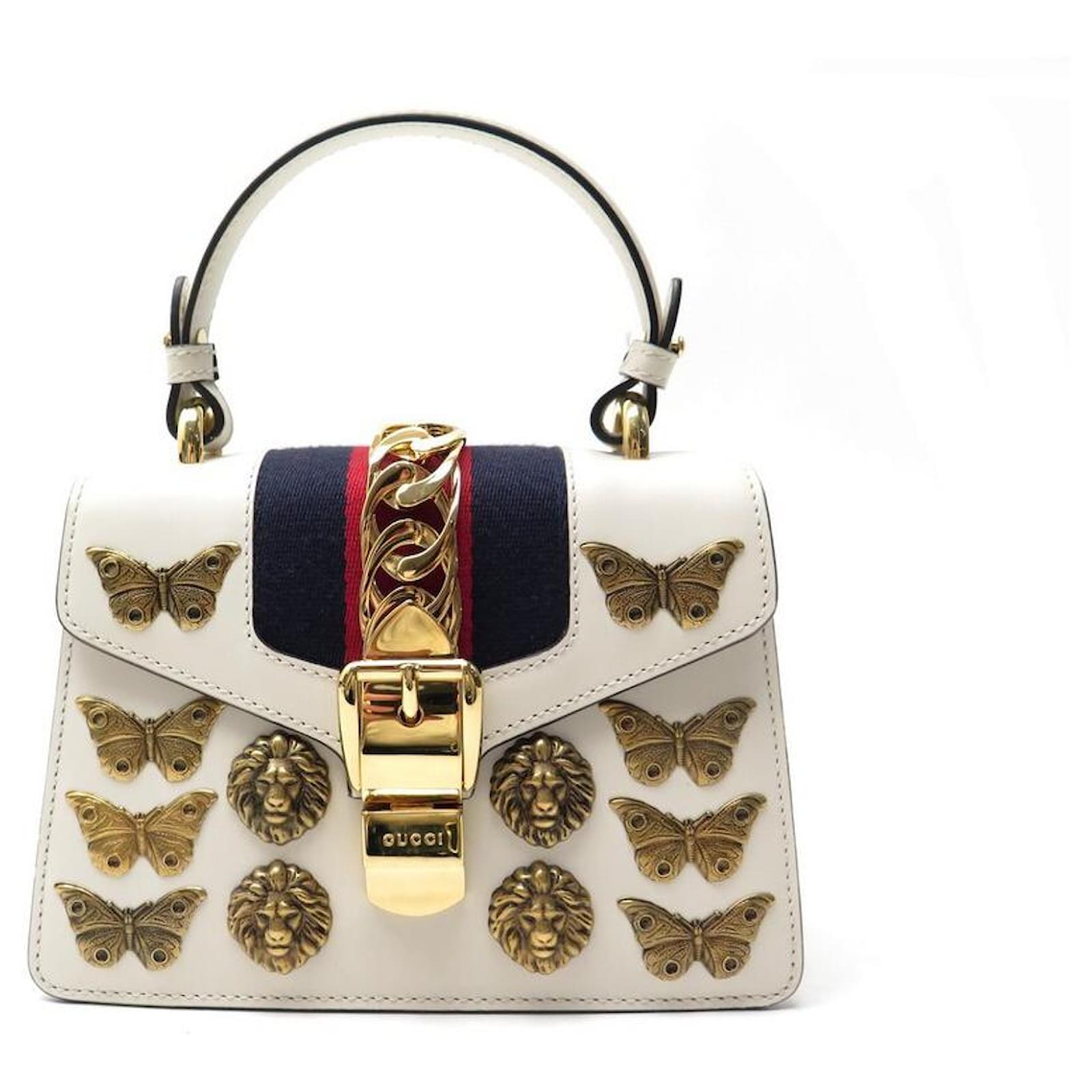 white gucci bag with butterfly