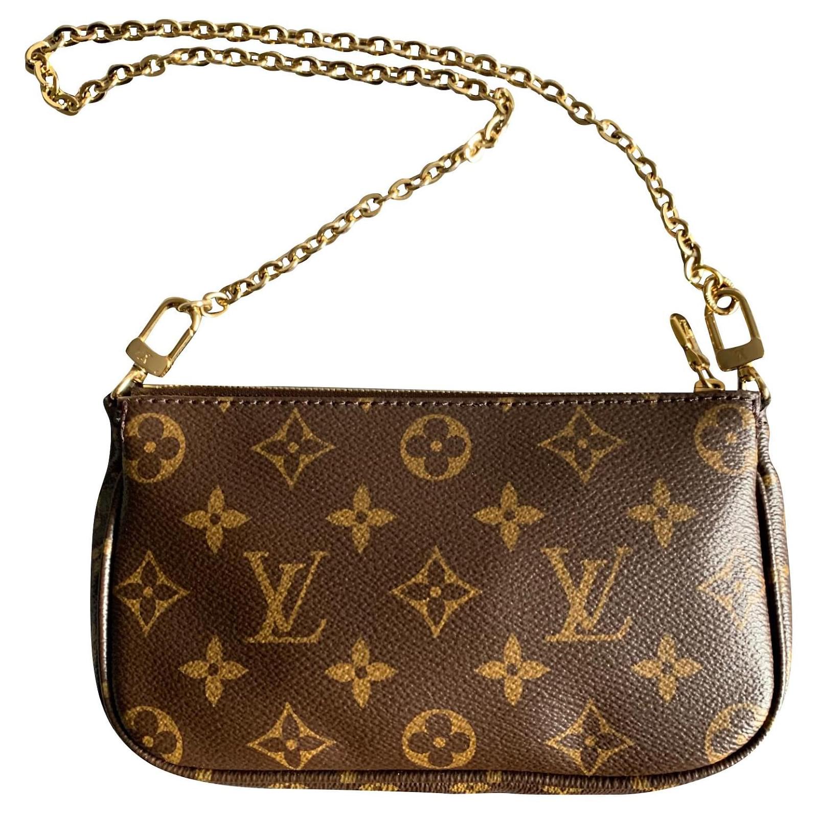 Pochette accessoire cloth handbag Louis Vuitton Brown in Cloth