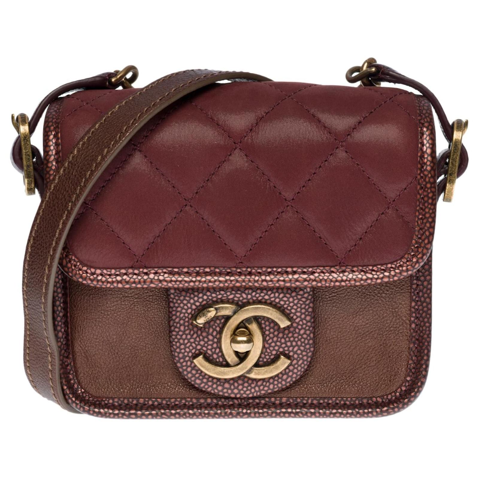 Superb and original mini Chanel burgundy bag in partially quilted leather,  hardware in aged gold metal