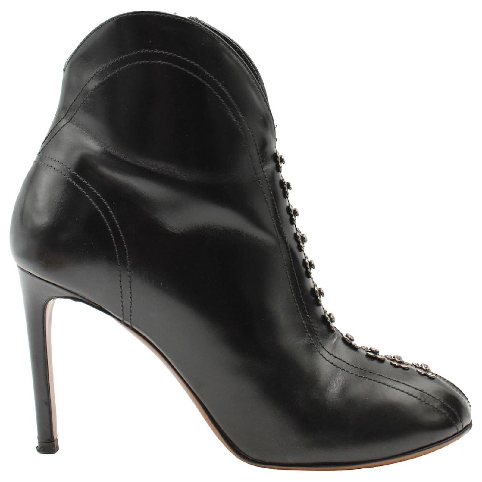 alaia hook and eye embellished booties in black leather